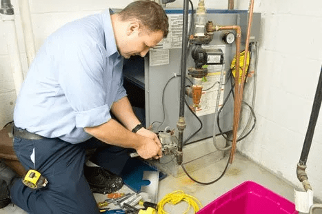 A technician repairing an HVAC system