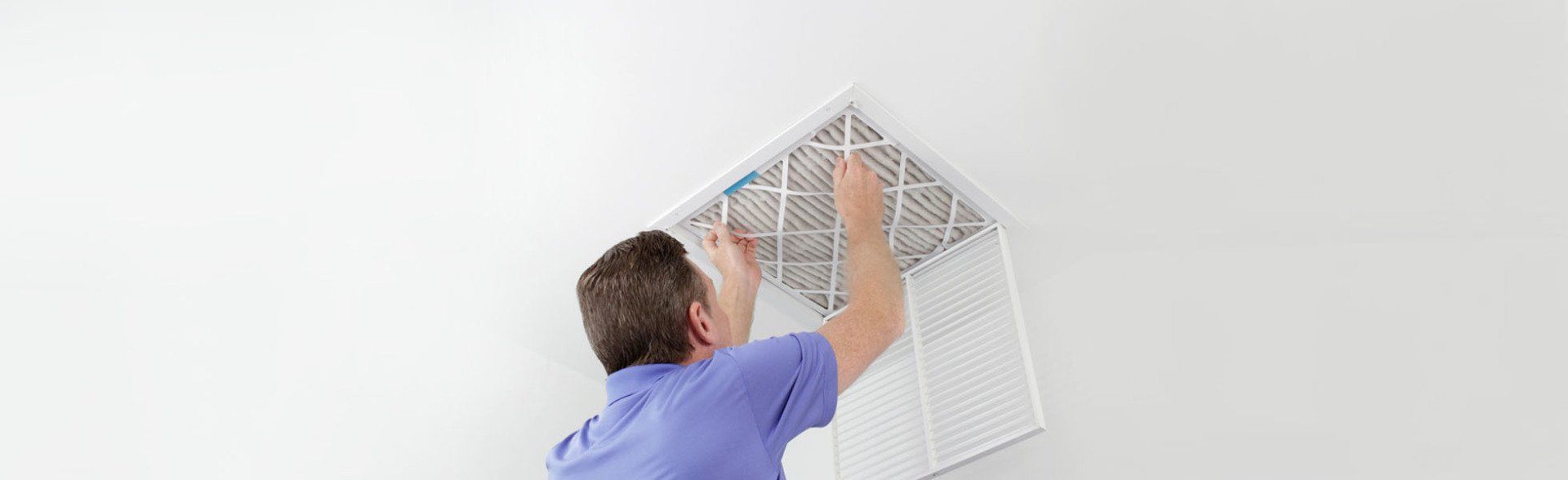 A man fixing an air ventilation